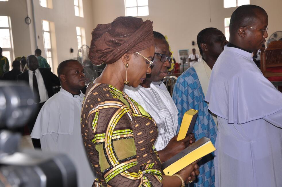 Gov. Okowa and wife holding the Ika Bible